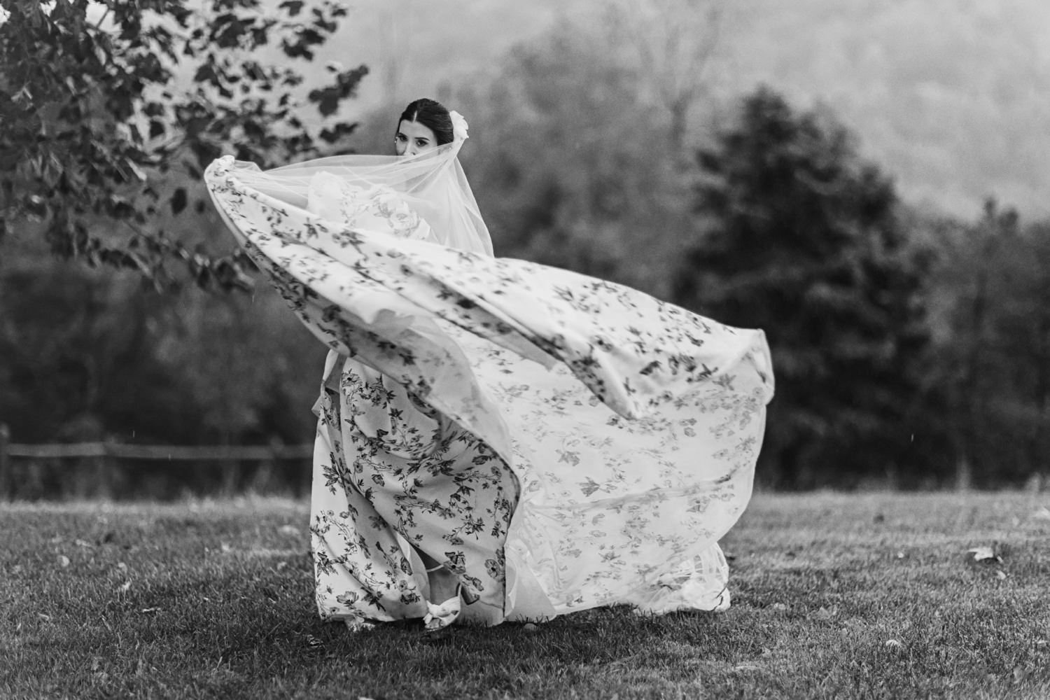 black and white photo of bride twirling in Blacksburg VA Farm