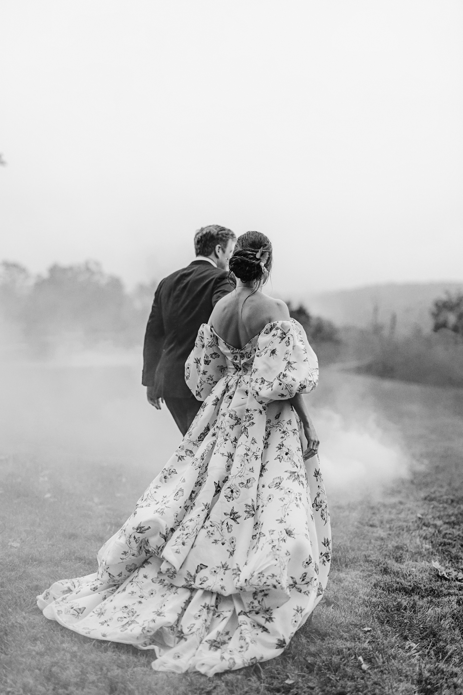 black and white photo of wedding couple walking at a Blacksburg VA Farm
